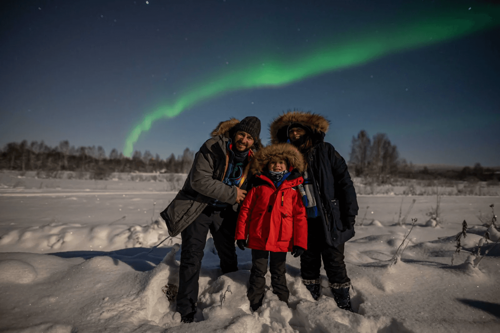 A family together under the northern lights